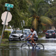 A man rides a bike on a flooded street following Hurricane Irma in North Miami, Florida
